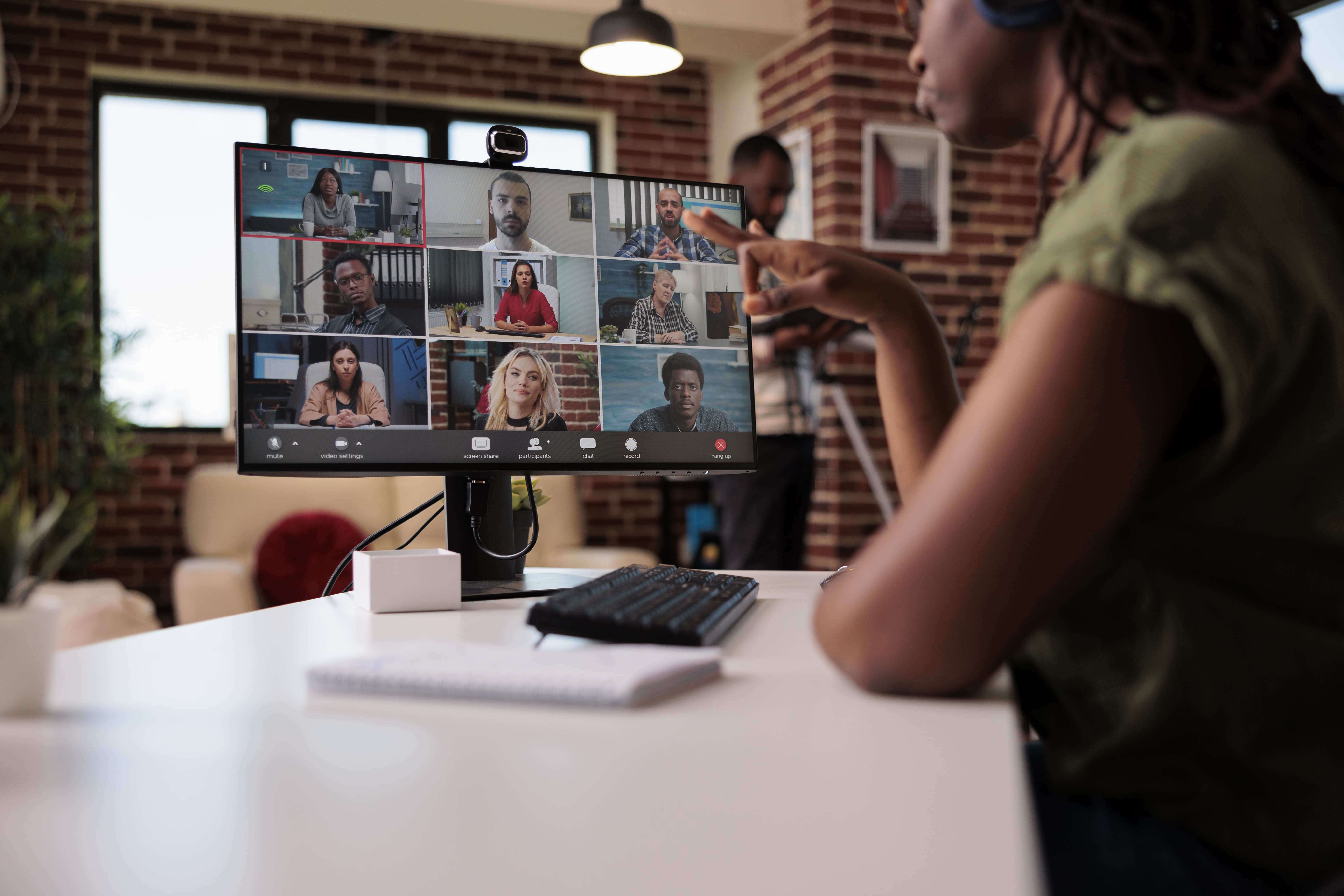 selective-focus-computer-screen-with-startup-team-startup-employees-working-remote-group-video-call-brainstorming-ideas-african-american-woman-gesturing-internet-meeting-with-colleagues (1).jpg